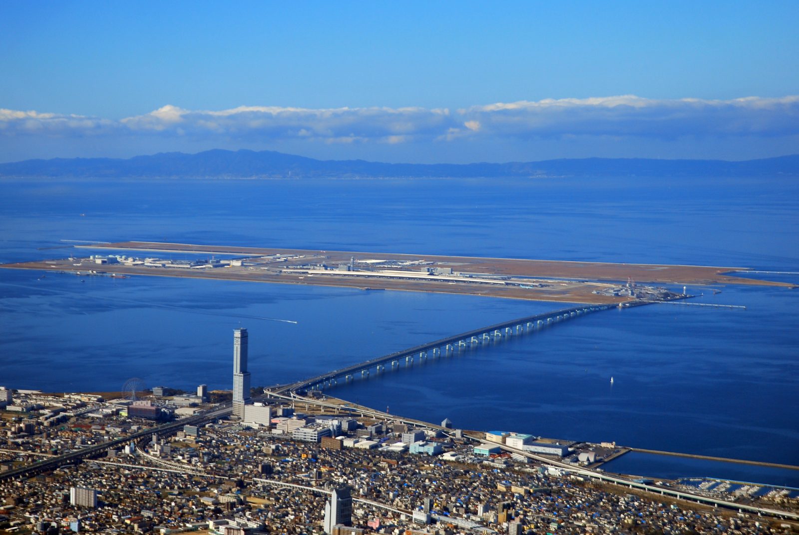 Aerial view of Kansai International Airport on its bay island with the connecting bridge