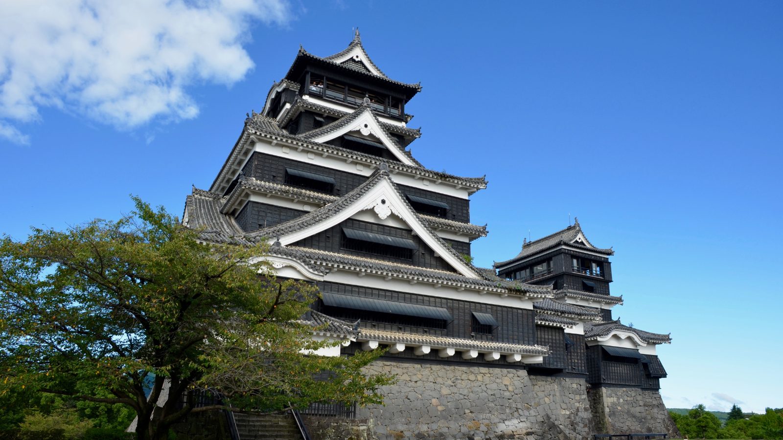 Kumamoto Castle keep against a blue sky
